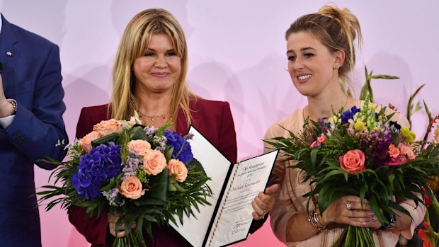 Corinna Schumacher and his daughter Gina accept the award for Michael Schumacher.