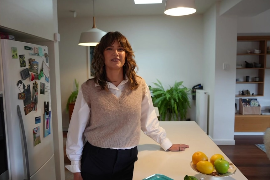 Marie Slako stands in her kitchen at home.