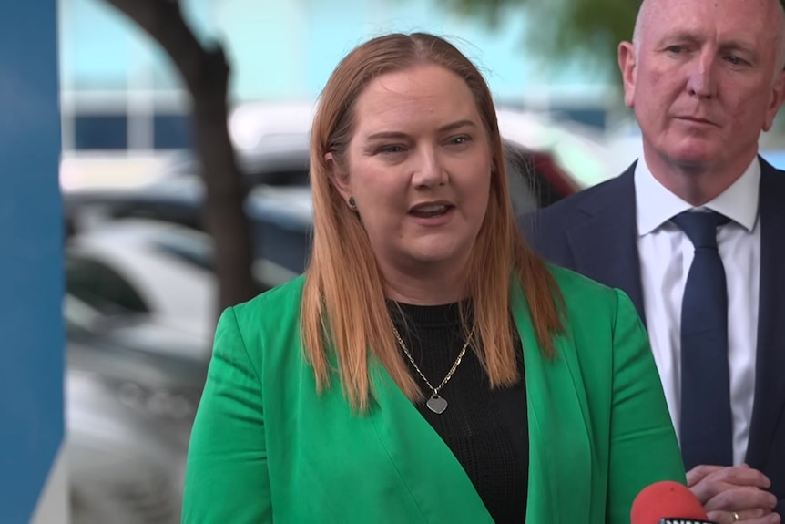 Jessica Stojkovski speaks to reporters while Stephen Dawson watches on.