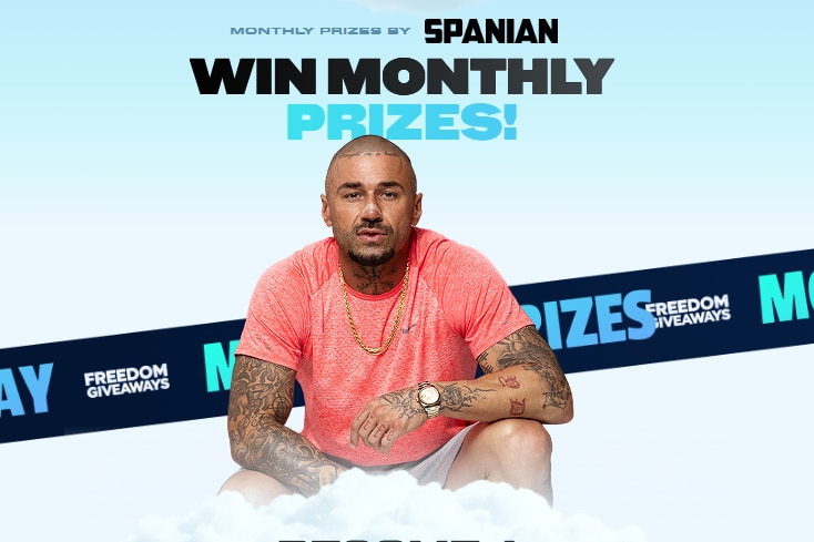 A man crouching in front of text that reads: "Win Monthly Prizes!"