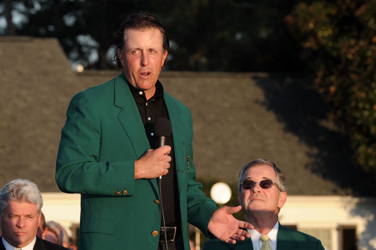 Phil Mickelson speaks to the gallery as Augusta National Chairman William Porter "Billy" Payne (R) looks on during the green jacket presentation after the final round of the 2010 Masters Tournament at Augusta National Golf Club on April 11, 2010