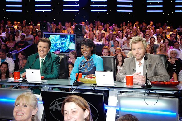 Kyle Sandilands (right), pictured with Mark Holden and Marcia Hines in the early 2000s, has had a long history as a judge on Australian Idol, both when the show was on Channel Ten and now on Channel Seven.