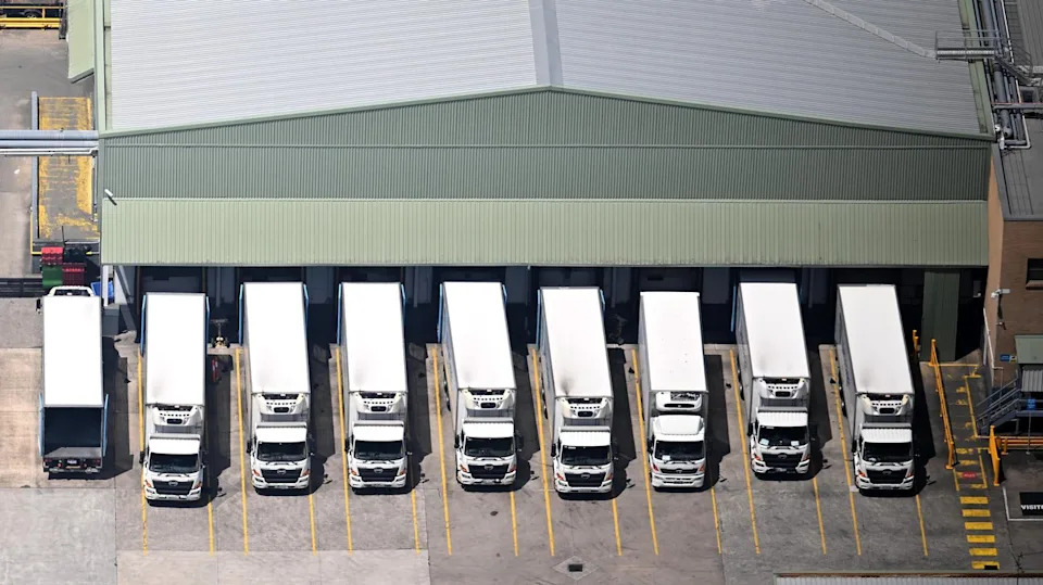 Trucks line up at a supply depot