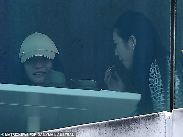 The only time Yang (left) has been photographed without a mask is when the Daily Mail snapped her with a friend dining at the Museum of Contemporary Art in September
