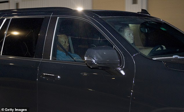 Woods appeared stony-faced as he sat in the passenger seat after eight hours behind bars