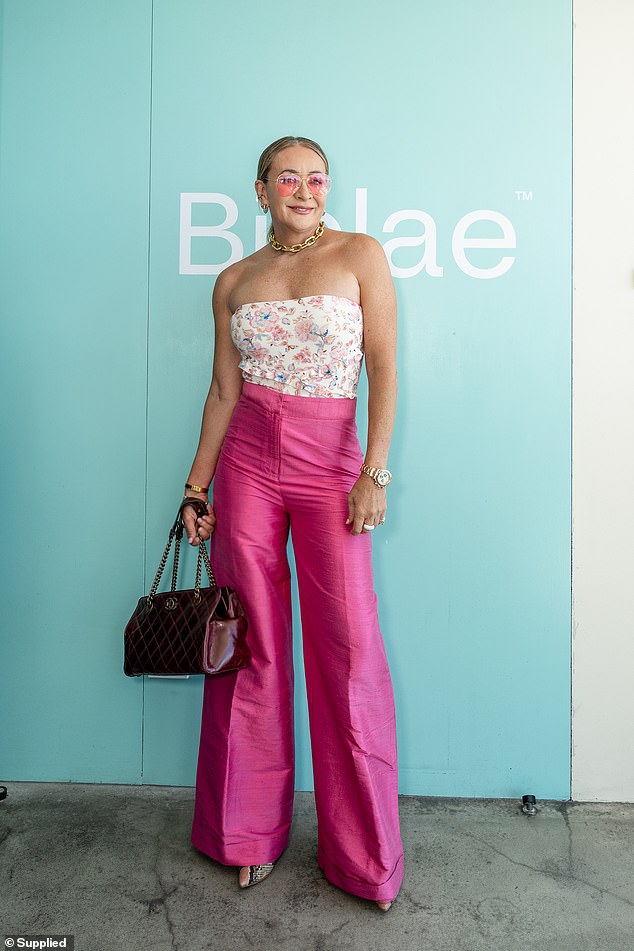 Michelle Bridges looked bright and colourful in a pair of hot pink high-waisted trousers