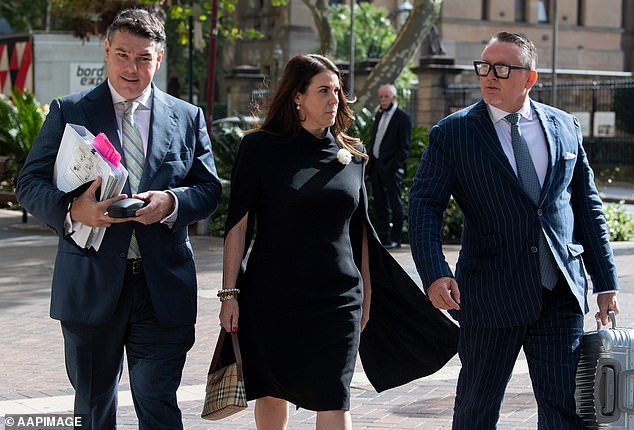 Flanked by lawyers, Emma Roberts arrives at the Federal Court in Sydney to testify against her former husband, Australia's most decorated soldier Ben Roberts-Smith