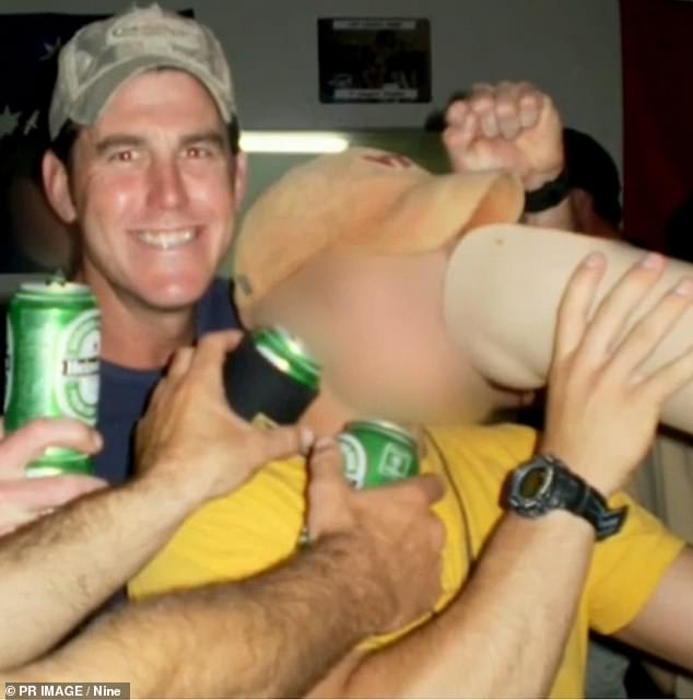 Ben Roberts-Smith and a fellow soldier who is drinking from a prosthetic leg taken from a man shot in Afghanistan in an event which forms part of the allegations against Roberts-Smith