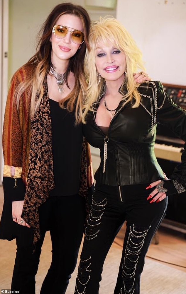 Dorothy is best known by fans for her bluesy vocals, with acclaimed albums to her name such as ROCKISDEAD and Gifts From the Holy Ghost. Pictured with Dolly Parton