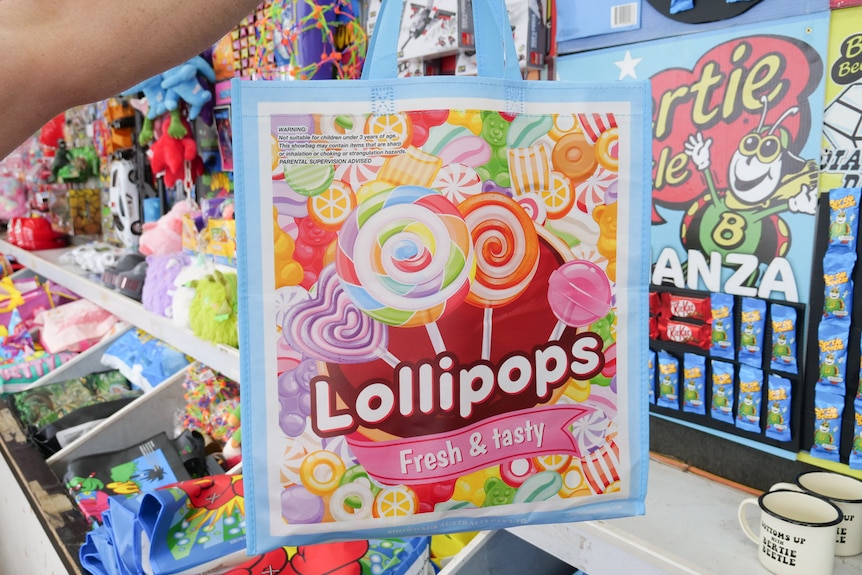 A showbag filled with lollipops held up in a showbag van. 