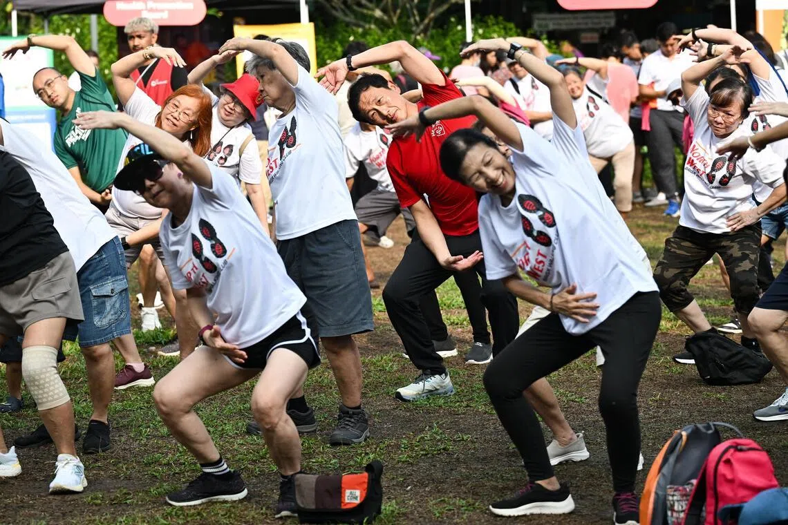 Health Minister Ong Ye Kung taking part in a mass cool-down exercise at a new brisk walking movement in Sembawang Central on April 12.