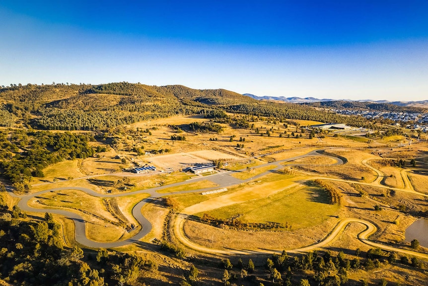 An aerial view of the park, with tracks through the grass.