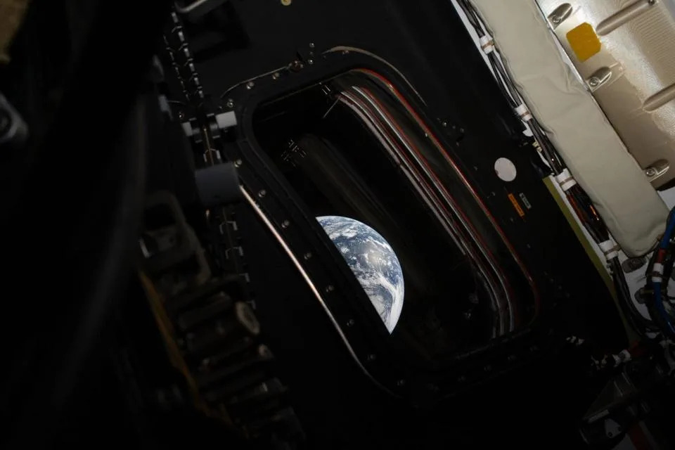 A view of Earth taken by NASA astronaut and Artemis II commander Reid Wiseman from one of the Orion spacecraft's four main windows after completing the translunar injection burn on April 2, 2026.  