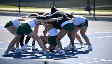 The 2025-26 tennis team huddles on the court at the Chippewa Club before playing its match against visiting Oakland