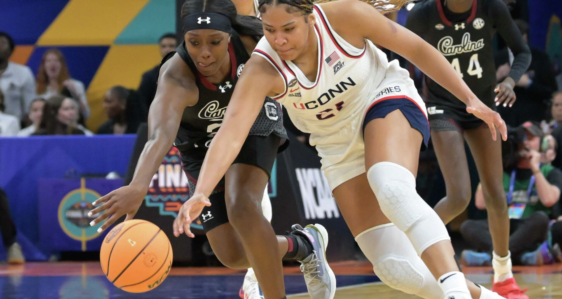 UConn’s Sarah Strong (21) runs down a loose ball before getting fouled by South Carolina's Raven Johnson (25) during their Final Four match up at the Mortgage Matchup Center in Phoenix, Arizona Friday, April 3, 2026.