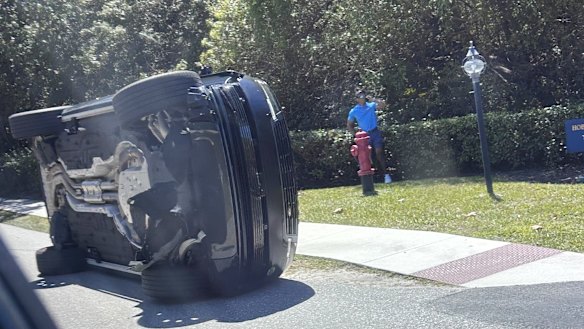 Tiger Woods can be seen on the phone at the crash site.