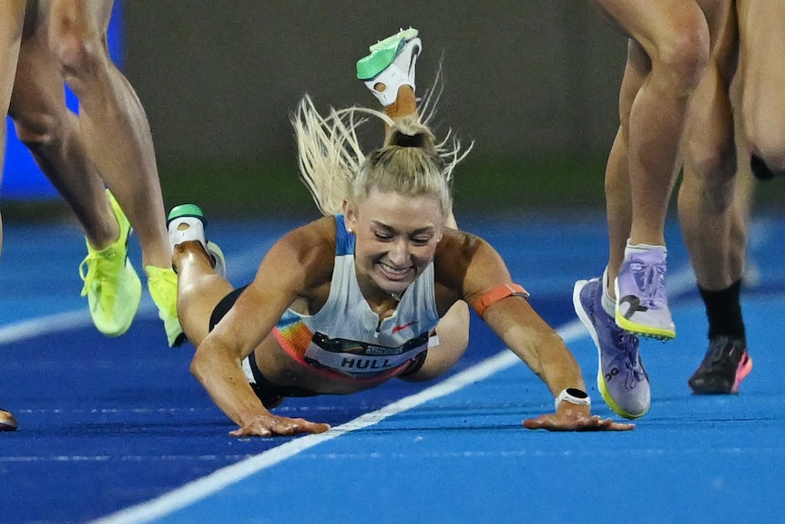 Runner Jess Hull falls and has arms splayed out in front of her