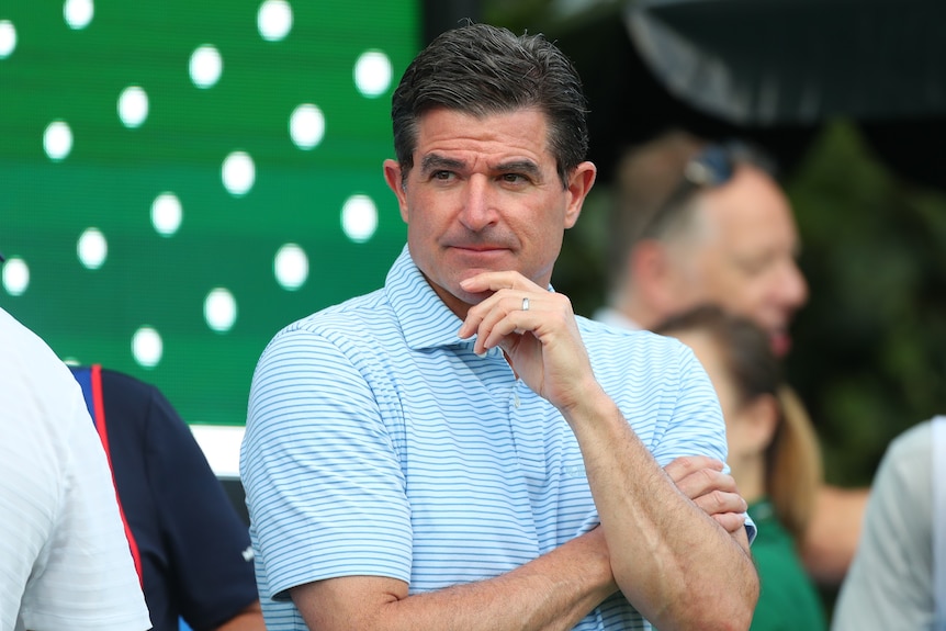 Golf executive standing on the first tee, looking into the distance