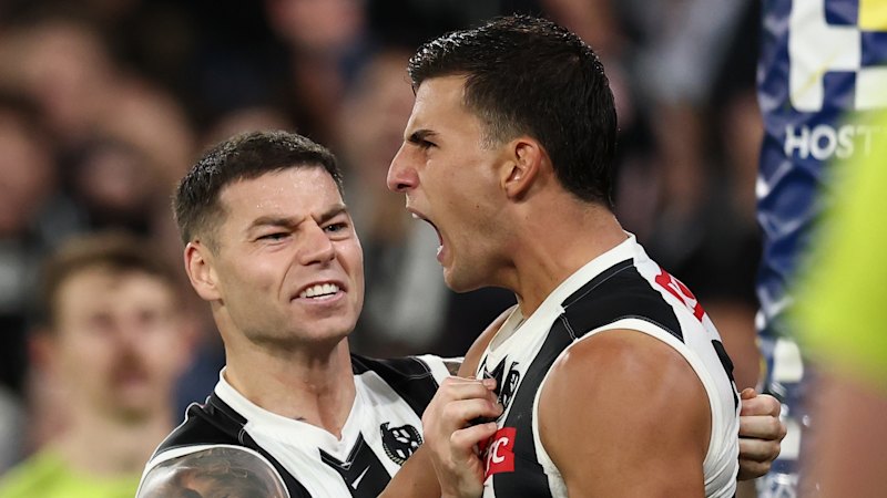 Carlton Blues coach Michael Voss wraps his arms around Elijah Hollands; Collingwood Magpies superstar Nick Daicos shines brightest