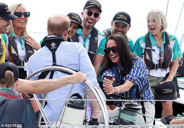 Britain's Prince Harry and Meghan, the Duke and Duchess of Sussex, sail on Sydney Harbour with veterans from the Invictus Australia community, in Sydney, Australia, April 17, 2026. REUTERS/Hollie Adams     TPX IMAGES OF THE DAY