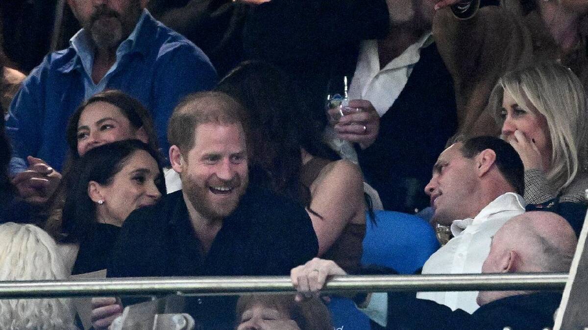 Harry and Meghan sat with Rugby Australia's Phil Waugh, who was delighted to host the couple. (Dan Himbrechts/AAP PHOTOS)