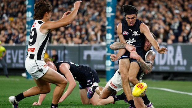 MELBOURNE, AUSTRALIA - APRIL 16: Elijah Hollands of the Blues is tackled by Tim Membrey of the Magpies during the 2026 AFL Round 06 match between the Carlton Blues and the Collingwood Magpies at the Melbourne Cricket Ground on April 16, 2026 in Melbourne, Australia. (Photo by Michael Willson/AFL Photos via Getty Images)