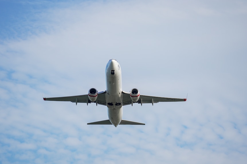 A generic under carriage of a plane taking off into the sky.