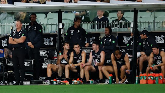 Elijah Hollands (right) on the bench in the last quarter.