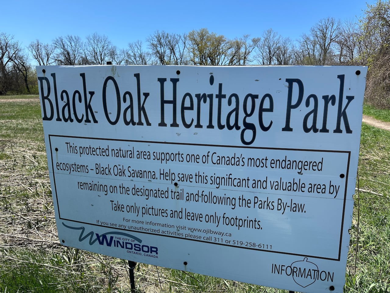 A sign at a wooded park.