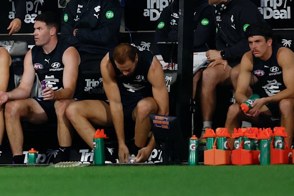 Elijah Hollands (right) on the bench in the last quarter.