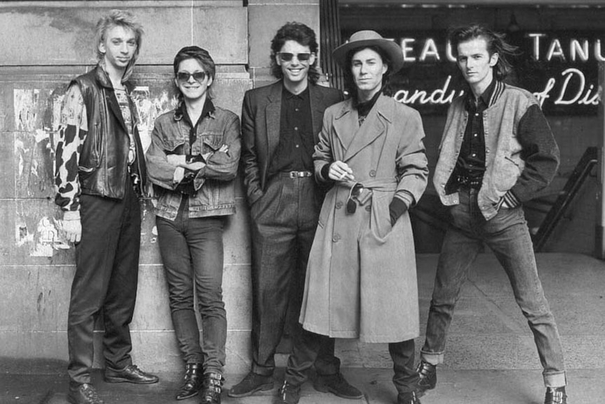 Black and white photo of a rock band in the 1980s. 