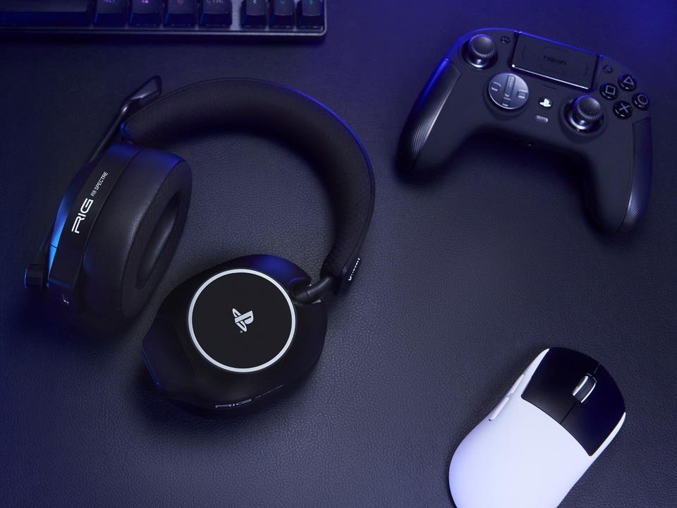 RIG R8 Spectre Pro headphones on a desk alongside a PS5 controller, mouse and keyboard.