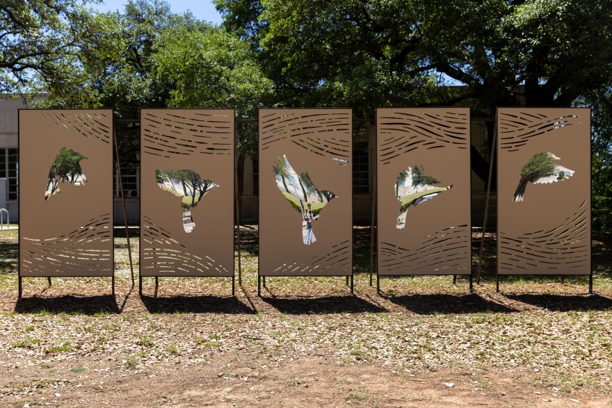 Jasna Boudard’s piece, ‘Wing Trace,’ reflects W. Cesar Chavez St. back to the Seaholm Lawn in Austin, Texas, on April 6, 2026. Joe Ferrara / KUT News