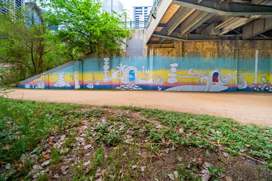 Seth Prestwood's Passages underneath the northside Drake Bridge Underpass depicts images of Austinites running, biking and paddleboarding on Lady Bird Lake.