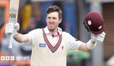 Somerset's Craig Overton raise his bat and helmet to celebrate scoring a centiry against Essex