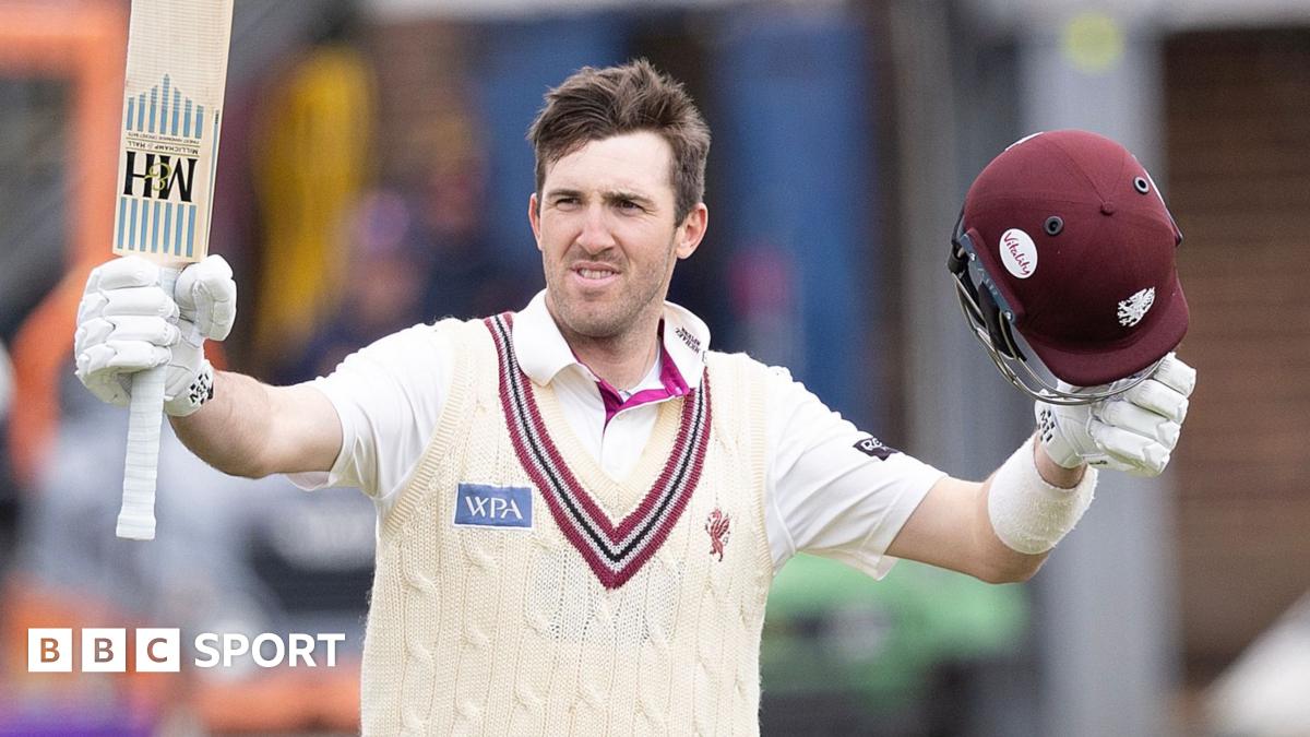 Somerset's Craig Overton raise his bat and helmet to celebrate scoring a centiry against Essex