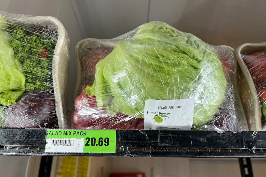 A small salad pack on a supermarket shelf, the price tag reads: $20.69