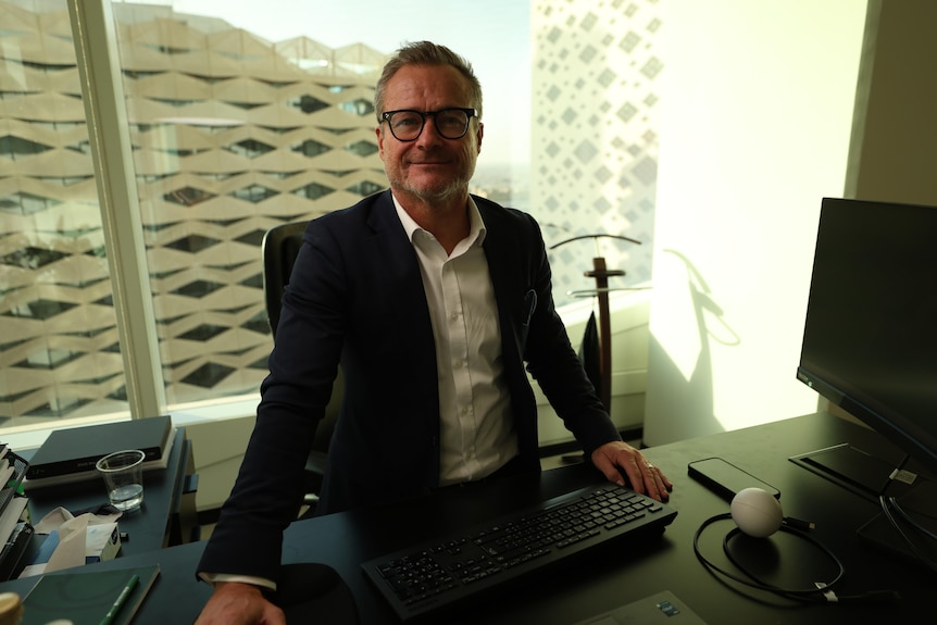 A man behind a desk.