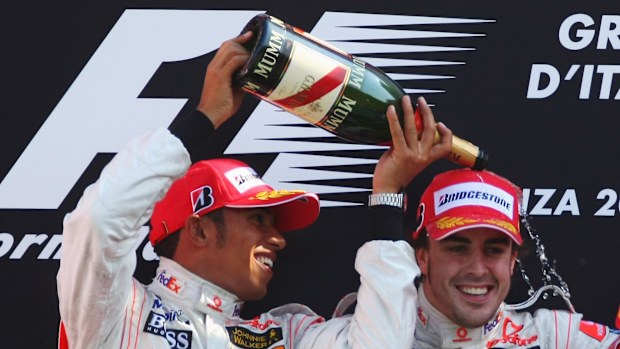 Second placed Lewis Hamilton of Great Britain and McLaren Mercedes and race winner Fernando Alonso of Spain and McLaren Mercedes celebrate on the podium after the Italian Formula One Grand Prix at the Autodromo Nazionale di Monza on September 9, 2007 in Monza, Italy. (Photo by Clive Mason/Getty Images)
