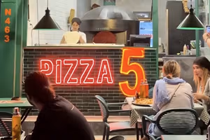 Dollar-pegged pizza in Tehran points to a different kind of regime change