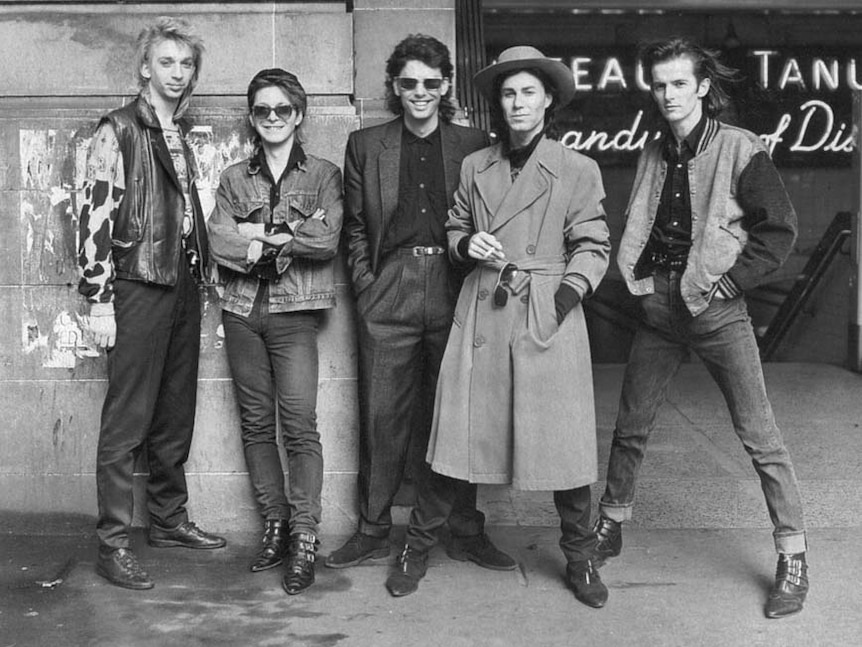 Black and white photo of a rock band in the 1980s. 