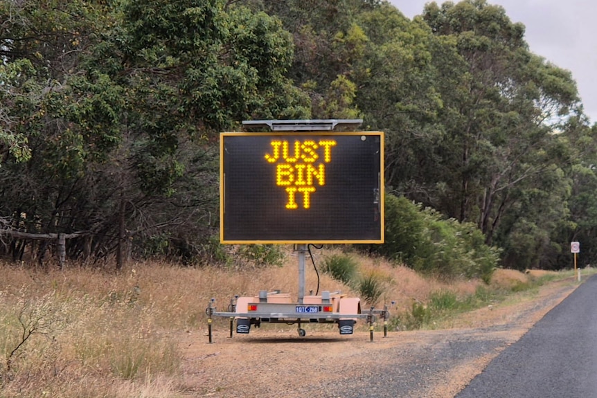A sign flashing Just Bin It