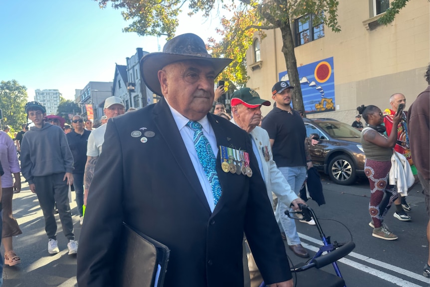Aboriginal man in a suit and hat with military metals and a blue tie in Indigenous art print
