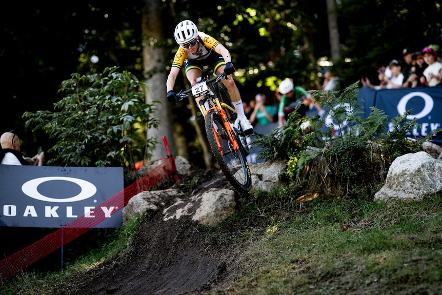 Rebecca Henderson goes over a mound on her bike