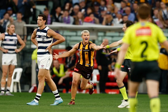 Hawthorn’s best player on Easter Monday Jack Ginnivan celebrates the win, while forlorn Geelong forward Shannon Neale laments the loss.