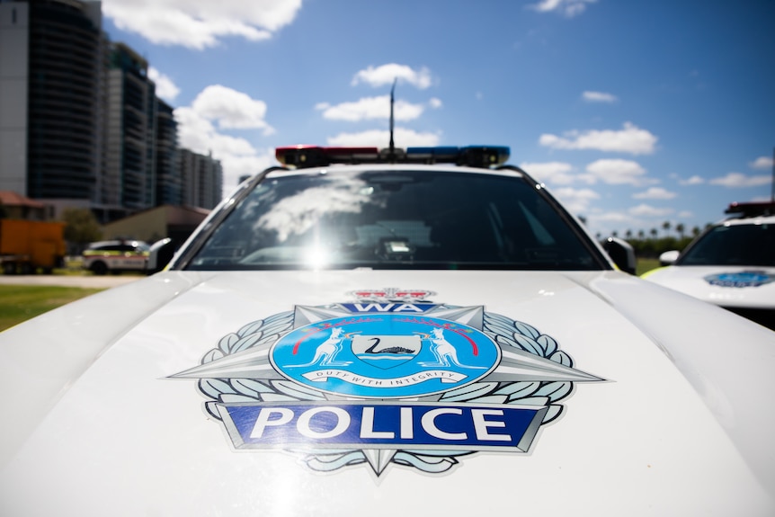 The WA Police crest on the bonnet of a parked car.