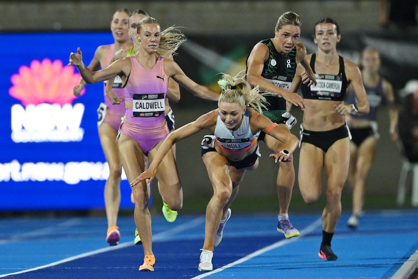 Jess Hull starts to fall to the ground as Abbey Caldwell and Claudia Hollingsworth continue behind her
