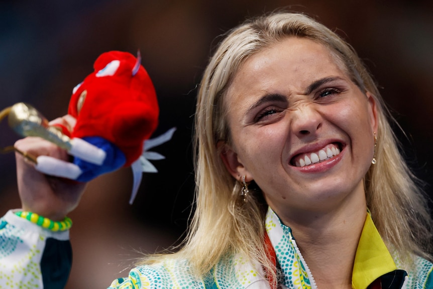 Alexa Leary of Australia celebrates on the podium with her gold medal and mascot