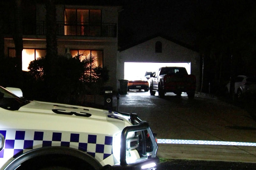 A night time image of a house and garage.
