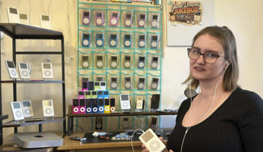Claire Hughes stands with her collection of old iPods. (Courtesy of Claire Hughes)